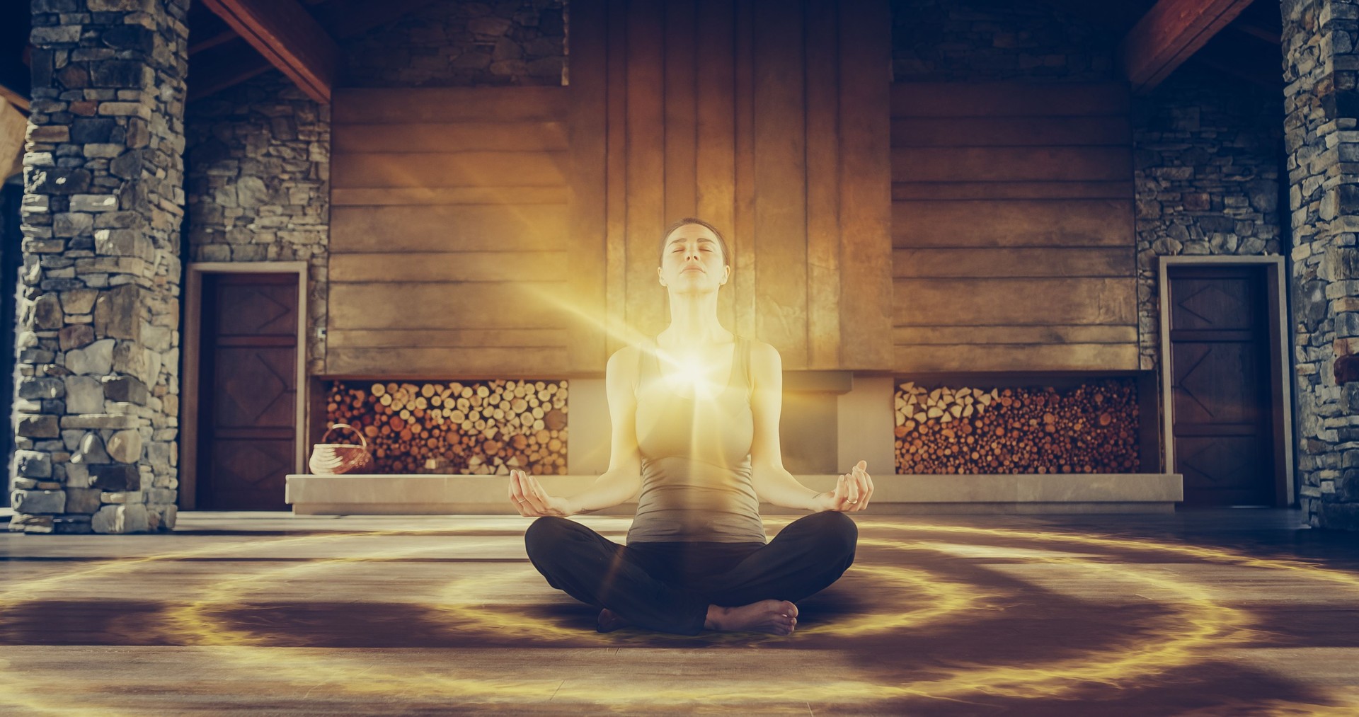 Beautiful Relaxed Caucasian Woman In Lotus Position Meditating In Zenlike Openair Space. Edited Visualization Of Bright Energy Accumulating In Her Chest. Yoga Practice, Self-care, Mindfulness Concept.